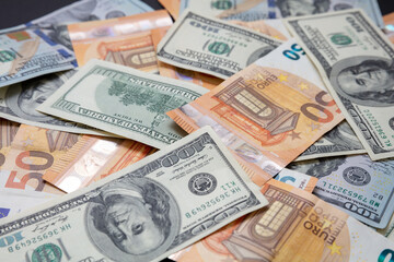 Banknotes background. Euro and US dollars notes pile