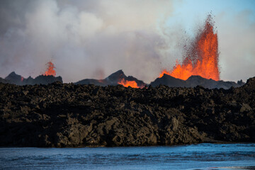 Fototapeta premium The 2014 Bárðarbunga eruption at the Holuhraun fissures across a river, Central Highlands, Iceland
