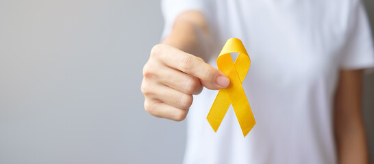 Suicide prevention day, Sarcoma, bone, bladder and Childhood cancer Awareness month, Yellow Ribbon for supporting people living and illness. children Healthcare and World cancer day concept - obrazy, fototapety, plakaty