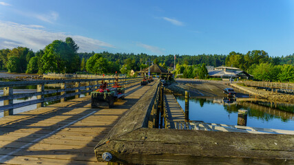 Fototapeta na wymiar Boat slip, viewed from a public pier at a BC park, early summer morning