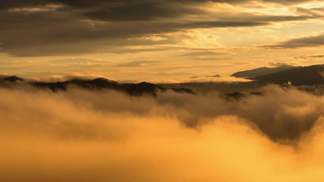 Timelapse video 4k, Aerial view Beautiful of morning scenery Golden light sunrise And the mist flows on high mountains, Wonder fog.