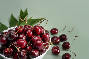 Close up fresh red cherries on white bowl.