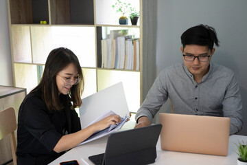 Business team discussing their project together in office.