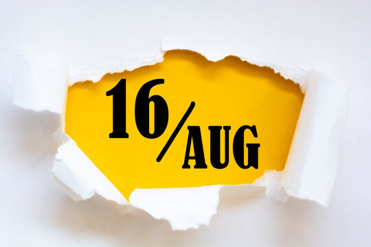 august 16. 16th day of the month, calendar date. Hole in paper with edges torn off. Yellow background is visible through ragged hole. Summer month, day of the year concept.