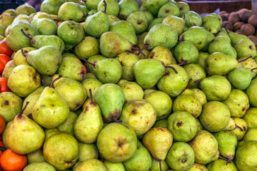 Green pear on display at the market