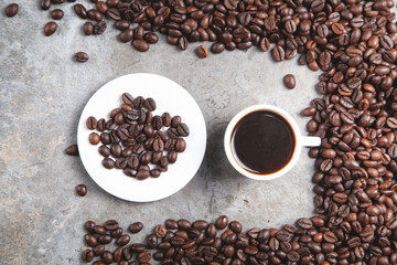 Cup of coffee on coffee beans.