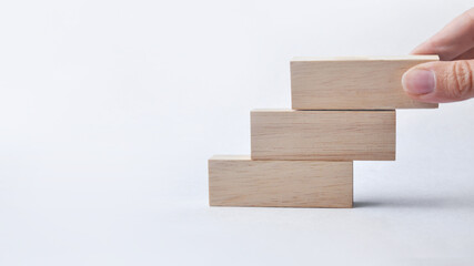 Wooden blocks in the form of a staircase. A symbol of a high career ladder and development