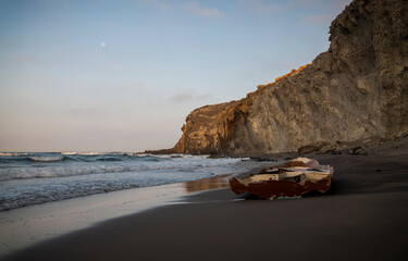 Fototapeta na wymiar Broken old boat on a beach in summer