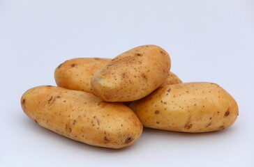 Fresh potatos stacked on white background