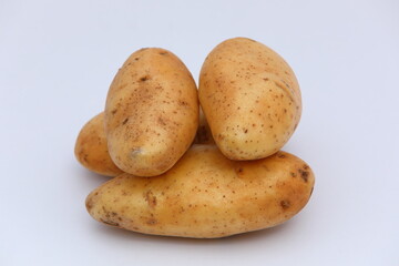 Fresh potatos stacked on white background