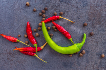 Hot peppers with spices on wooden table close up