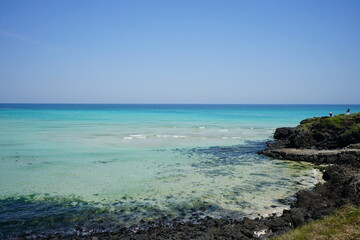 a beautiful seaside landscape with clear bluish water