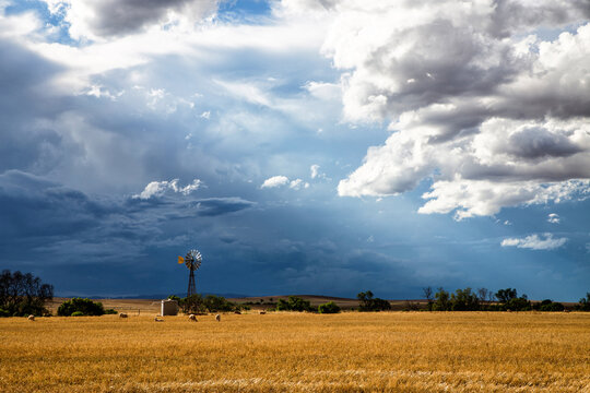 windmill in front of storm clouds