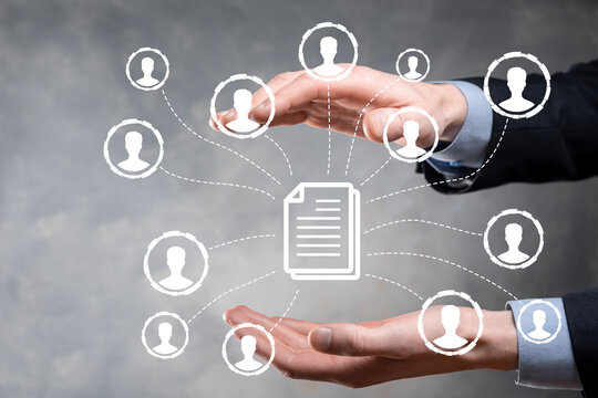 Man hold document and user icon.Corporate data management system DMS and document management system concept. Businessman click or publish on document connected with corporate users