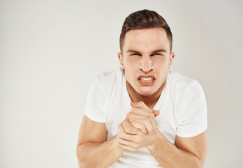 angry man in white t-shirt emotion displeasure close-up