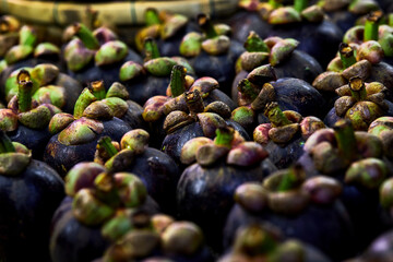 close up lot of ripe mangosteen on table