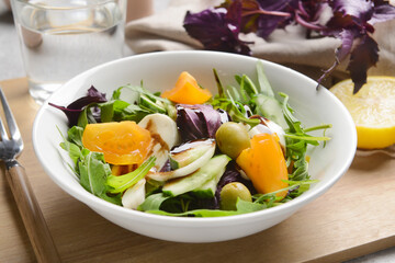 Bowl with tasty fresh salad on table, closeup
