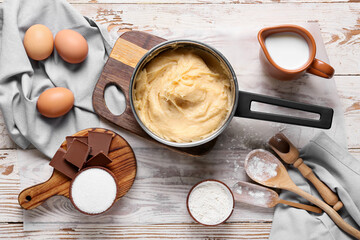 Ingredients for preparing churros on light wooden background