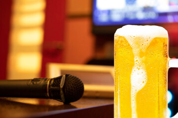 Image of karaoke and a mug of beer