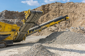 Heavy and mobile machinery in a quarry to transform stone into construction material