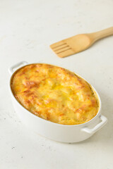 Casserole with mashed potatoes on light background