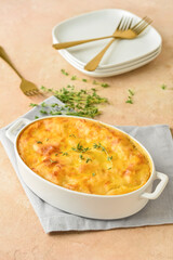 Casserole with mashed potatoes on color background