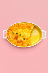 Casserole with mashed potatoes on color background