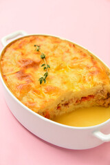 Casserole with mashed potatoes on color background, closeup