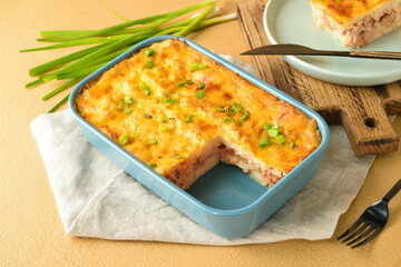Casserole with mashed potatoes on color background