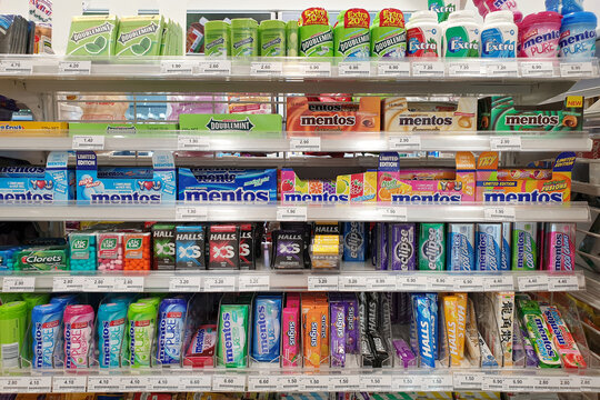 Various choices of candies and chewing gum on the store shelf in FamilyMart. FamilyMart is the 3rd largest Japanese convenience store franchise chain in Japan and Asia. PENANG, MALAYSIA - 4 AUG 2021.