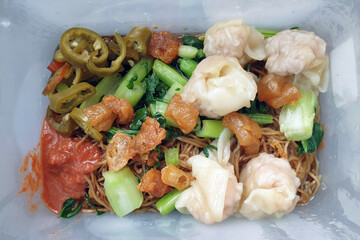Top view image Wonton noodles in a plastic takeaway box.