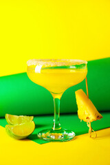 Glass of pineapple daiquiri cocktail on color background