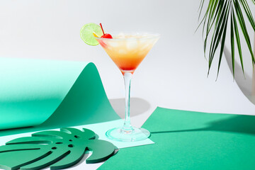 Glass of tasty summer cocktail on color background