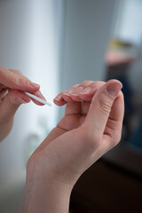 nail care. the girl sharpens her nails with a nail file. a broken nail. girl takes care of manicure manicure nail file thumb broken nail