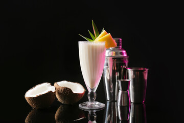 Glass with tasty Pina Colada cocktail on dark background