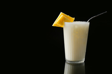 Glass with tasty Pina Colada cocktail on dark background
