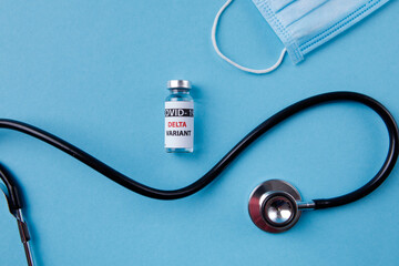 Vaccine bottles covid - 19 delta variant, vials medicine and syringe injection isolated on blue....