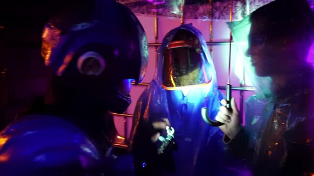 Cyberpunk future. Police officer halfman bionic cyborg is walking through night street area, cop is looking for intruder fugitive or illegal immigrant and checks identity of suspicious person.