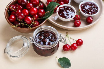 Composition with tasty cherry jam on color background, closeup