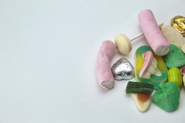 close-up of pile of sweets on white background with copy space