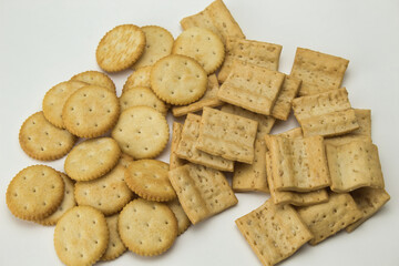 top view of salty square and round cookies on white background
