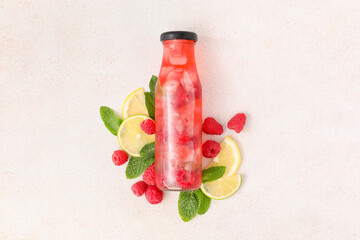 Bottle of tasty lemonade with raspberry on white background