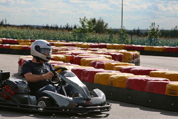 Karting competition or racing cars riding for victory on a racetrack