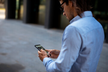 Close up of businessman using the phone. Young manager typing a message