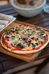 Delicious pizza on a wood table with fajitas