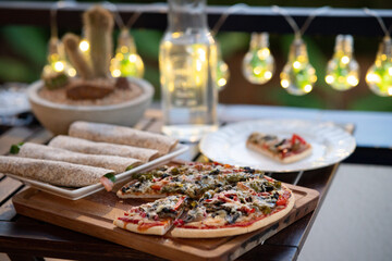 Delicious pizza on a wood table with fajitas