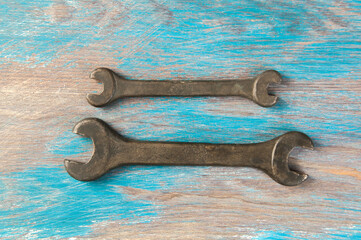 Set of two vintage bronze wrench on shabby background