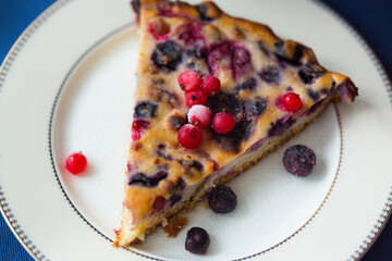 Piece of homemade berry pie with red currant, blueberry, cherry and ricotta cheese