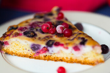 Piece of homemade berry pie with red currant, blueberry, cherry and ricotta cheese