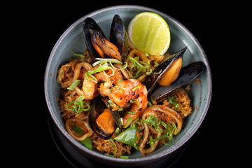 Meat with rice and vegetables on black background